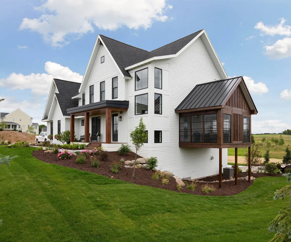 Two-story home with balanced rooflines, coordinated exterior materials and welcoming curb appeal”
